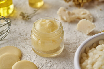 Homemade cosmetic cream made of shea butter, cocoa butter, essential oils and beeswax