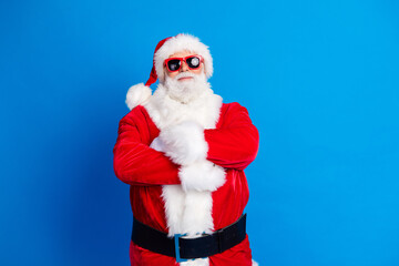 Fototapeta na wymiar Photo portrait of retired old man folded arms confident wear trendy santa claus costume coat isolated on blue color background