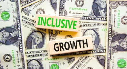 Foto op Canvas Inclusive growth symbol. Concept words Inclusive growth on beautiful wooden blocks. Dollar bills. Beautiful background from dollar bills. Business inclusive growth concept. Copy space. © Dzmitry