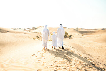 Three generation family making a safari in the desert of Dubai. Grandfather, son and grandson...