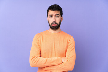 Caucasian handsome man over isolated purple background with sad and depressed expression