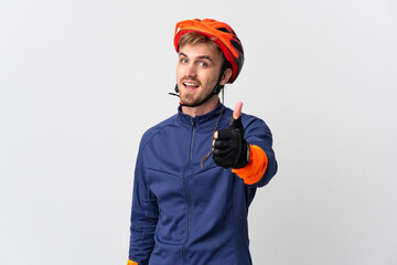 Young cyclist blonde man isolated on white background with thumbs up because something good has...
