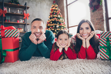 Fototapeta premium Full length photo of positive nice people hands touch cheeks lying carpet floor festive giftbox tree illumination indoors