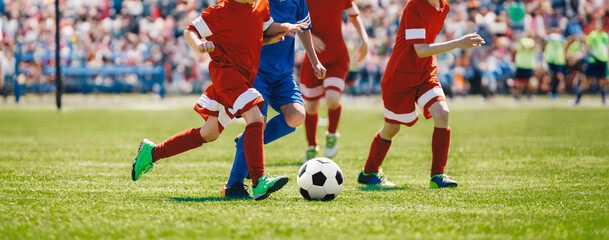 Football soccer match for children. Boys playing a football game in a school tournament. Picture of...