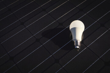 LED lamp on the background of a solar panel. The concept of ecology and sustainability, renewable...