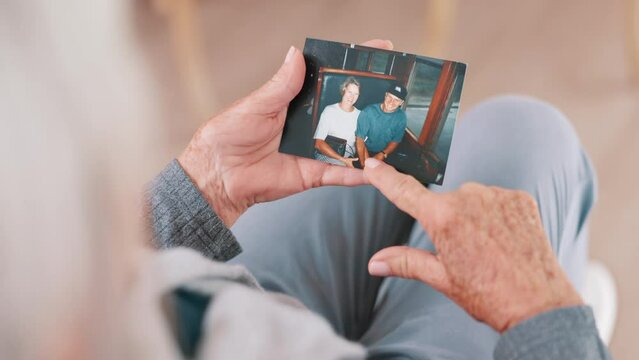 Photograph, memory and old woman in home remember date, event and marriage with nostalgia. Elderly, hands and mourning death of husband or person in vintage picture with love and thinking of history