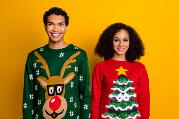 Photo of adorable charming guy girl dressed christmas ugly print pullovers smiling isolated yellow color background