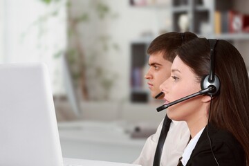 Technical support worker with a headset in modern office.
