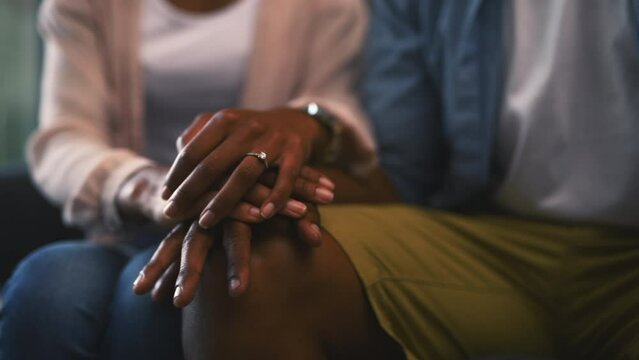Holding hands, love and couple in marriage support on couch, rings commitment and partner loyalty. People, trust and gratitude for bonding with care, together and wellness with union in relationship