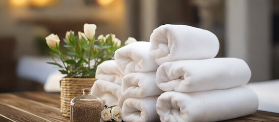 Fototapeta na wymiar Towels and flowers on wooden table in spa salon, closeup. Generative AI