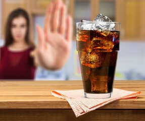 Young woman make stop sign showing on junk drink