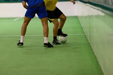 Naklejka premium Five-a-side players with ball trying to score a goal for their team.