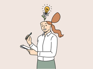Business woman with flower growing from head and light bulb, metaphor for having creative ideas to increase productivity. Lady writes down new ideas in notebook so as not to forget and choose best one