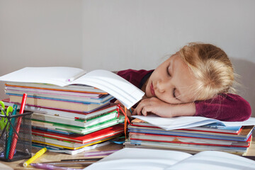 Homework Help. Exhausted Tired Little Child Schoolgirl Sleeping Asleep at Desk on Pile of Books. Problems with Homework, Difficulties in Elementary School.