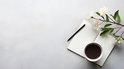  a cup of coffee sitting on top of a table next to a notepad and a pen on top of a paper.
