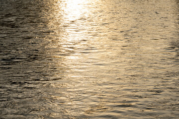 sunlight reflected in the water at sunset.