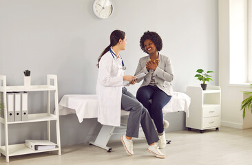 Female GP doctor having discussion about patient diagnosis. Smiling female therapist giving advice...