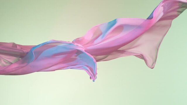 Pastel color transparent silk fabric flowing by wind, super slow motion. Fiilmed on high speed cinematic camera at 1000 fps.