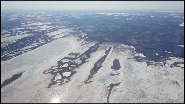 Flying along the Hudson Bay coastline of Nunavut, Canada near Arviat