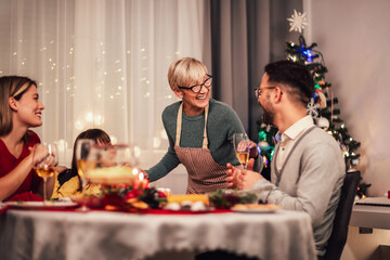 Happy multi-generation family enjoying in a lunch together at home. Family on Christmas dinner at home