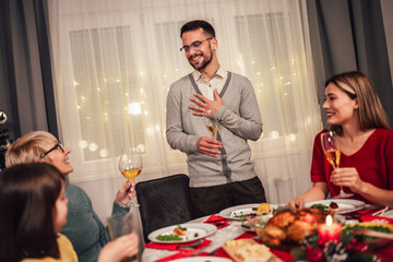 Happy multi-generation family enjoying in a lunch together at home. Family on Christmas dinner at home