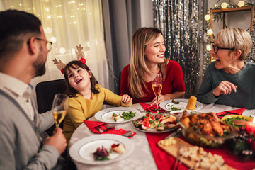 Photo captures the warmth and joy of a Christmas dinner with a beloved grandmother, mother, father, and daughter
