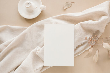 Blank paper mockup on linen fabric. An aesthetic paper card template for a wedding, birthday. The...