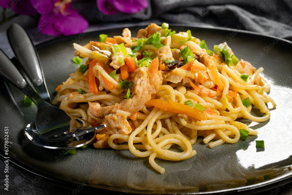 Poster Fried noodles with chicken and vegetables.