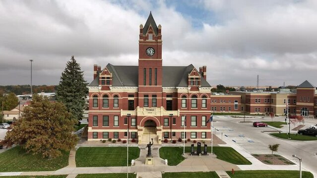 Flying in towards Colby City Municipal Courthouse in Kansas on cloudy day.