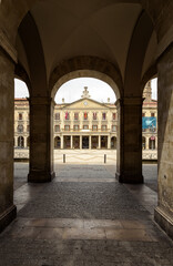 Fototapeta na wymiar Porticoed square called as Spain Square or Plaza de Espana with the Town Hall in the background, Vitoria-Gasteiz, Alava, Basque Country, Spain