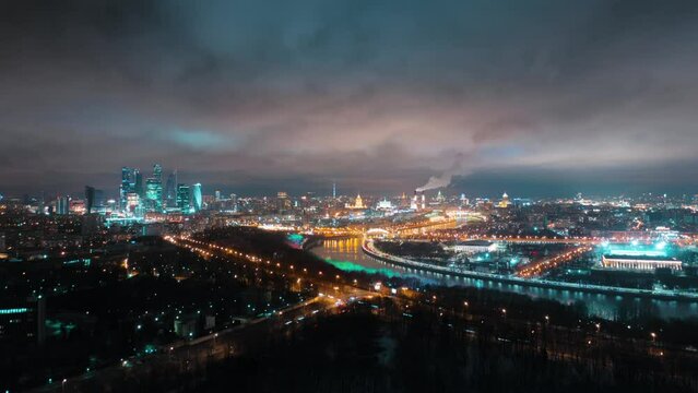 An amazingly beautiful hyperlapse of Moscow's Sparrow Hills on a foggy night with glittering traffic lights, business center buildings in the background, and the Moskva River.
