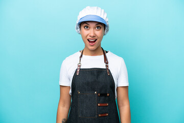 Fishwife Argentinian woman isolated on blue background looking up and with surprised expression