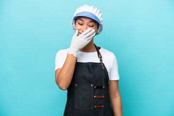 Fishwife Argentinian woman isolated on blue background happy and smiling covering mouth with hand