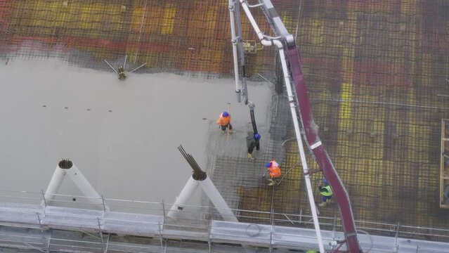 building a floor by pumping liquid concrete for Concreting on a construction site