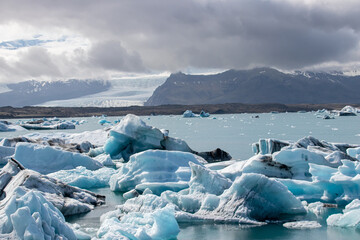 Ice floes in a glacial lake in Iceland with vulcano mountains in the background, the climate crisis...