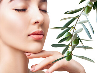 Beautiful young woman near green natural olive leaves.