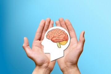 Mental health and memory concept. Hands holding a human head