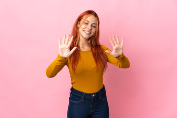 Teenager Russian girl isolated on pink background counting ten with fingers