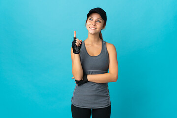 Teenager sport russian girl isolated on blue background pointing up a great idea