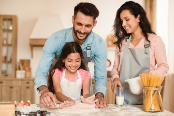 Fototapeta premium Family enjoys baking in sunny kitchen