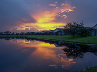 Sunset over villas in Florida. reflected in lake at dusk.