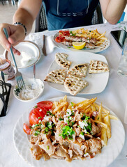 Dishes on the table with people eating