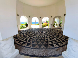 A rotunda inside the Kallithea Springs with arches and mosaic floor made from round black and white beach pebbles. Rhodes, Greece.
