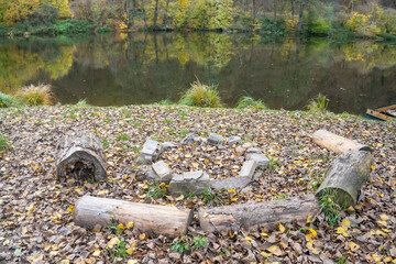 Picnic wooden benches by the river Berunka in autumn season, to relax
