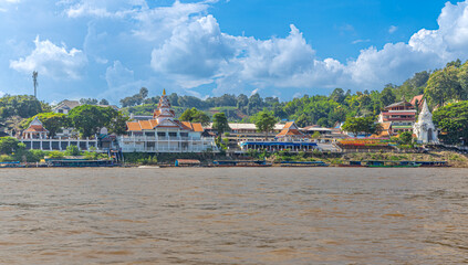 Golden Triangle the 3 borders of Thailand Laos and Myanmar lovely Golden Buddha on the Mekong River with boats in the river and mountains in the background 