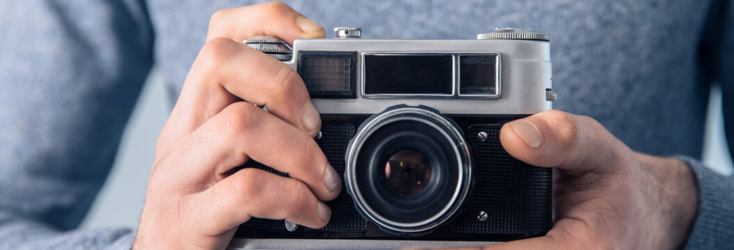 man holding vintage camera