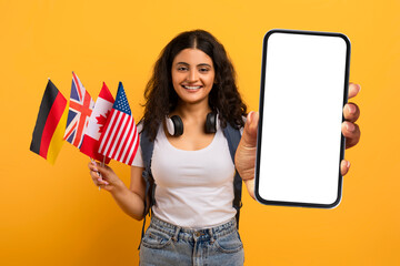 Cheerful young indian woman student with many different flags