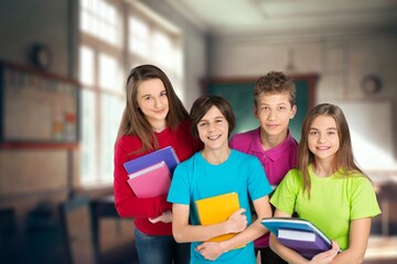 Happy young students while studying with friends in school