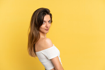 Young caucasian woman isolated on yellow background . Portrait