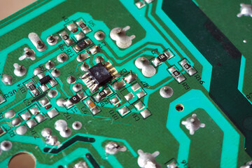 Damaged semiconductor chip on electronic circuit board.